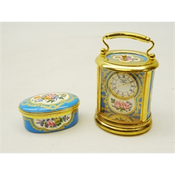  Halcyon Days miniature carriage clock of oval form with cartouche panels decorated with flowers, brass frame and handle, H10.5cm and trinket box both inspired by the decoration on a Sevres porcelain plaque (2)  
