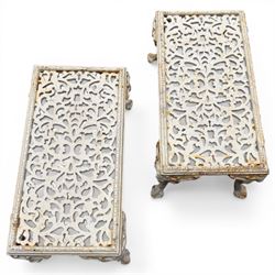 Pair of cast iron low garden tables with rams head legs in a white finish
