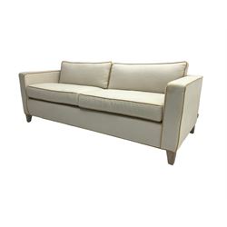 Neptune - pair three seat 'Shoreditch' sofas,  upholstered in cream fabric with yellow stringing