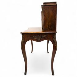 Late 19th-century Louis XV revival gilt bronze mounted and walnut Bonheur-de-Jour, rectangular-shaped serpentine form, with gilt bronze beading, frieze with two blind drawers and gilt bronze handles, centre drawer with large central serves style porcelain plaque, the elevated section with brass gallery above panelled cupboard doors also with serves style porcelain plaques and gilt bronze mounts, interior with single shelf, central section with four drawers each with gilt bronze handles, raised on slender cabriole legs fitted with gilt bronze rococo style masks and sabots