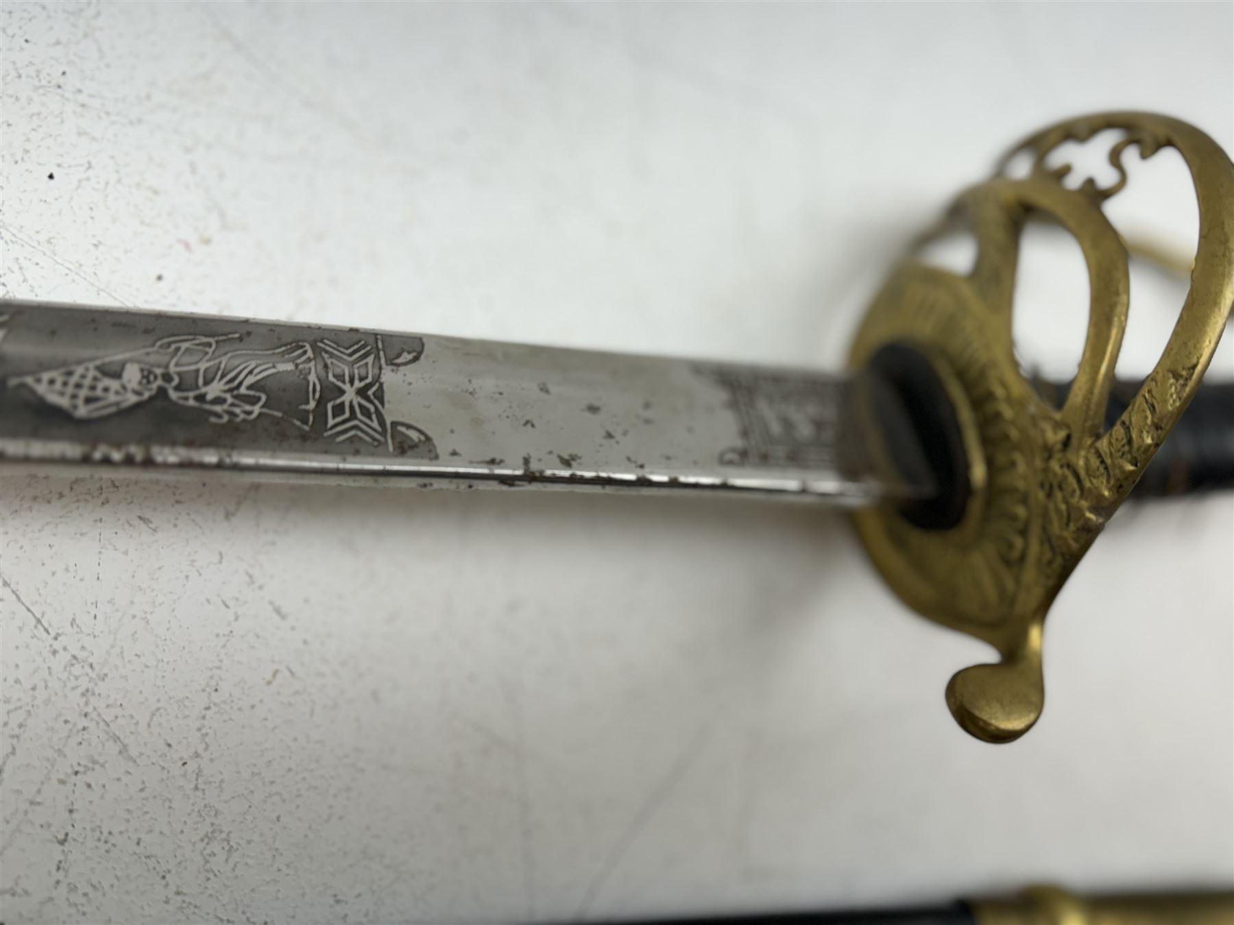 Replica Confederate States Army officer's sword, with brass pommel, black leather hand grip, the 85cm single edged blade marked CSA, in a metal and brass scabbard, L106cm