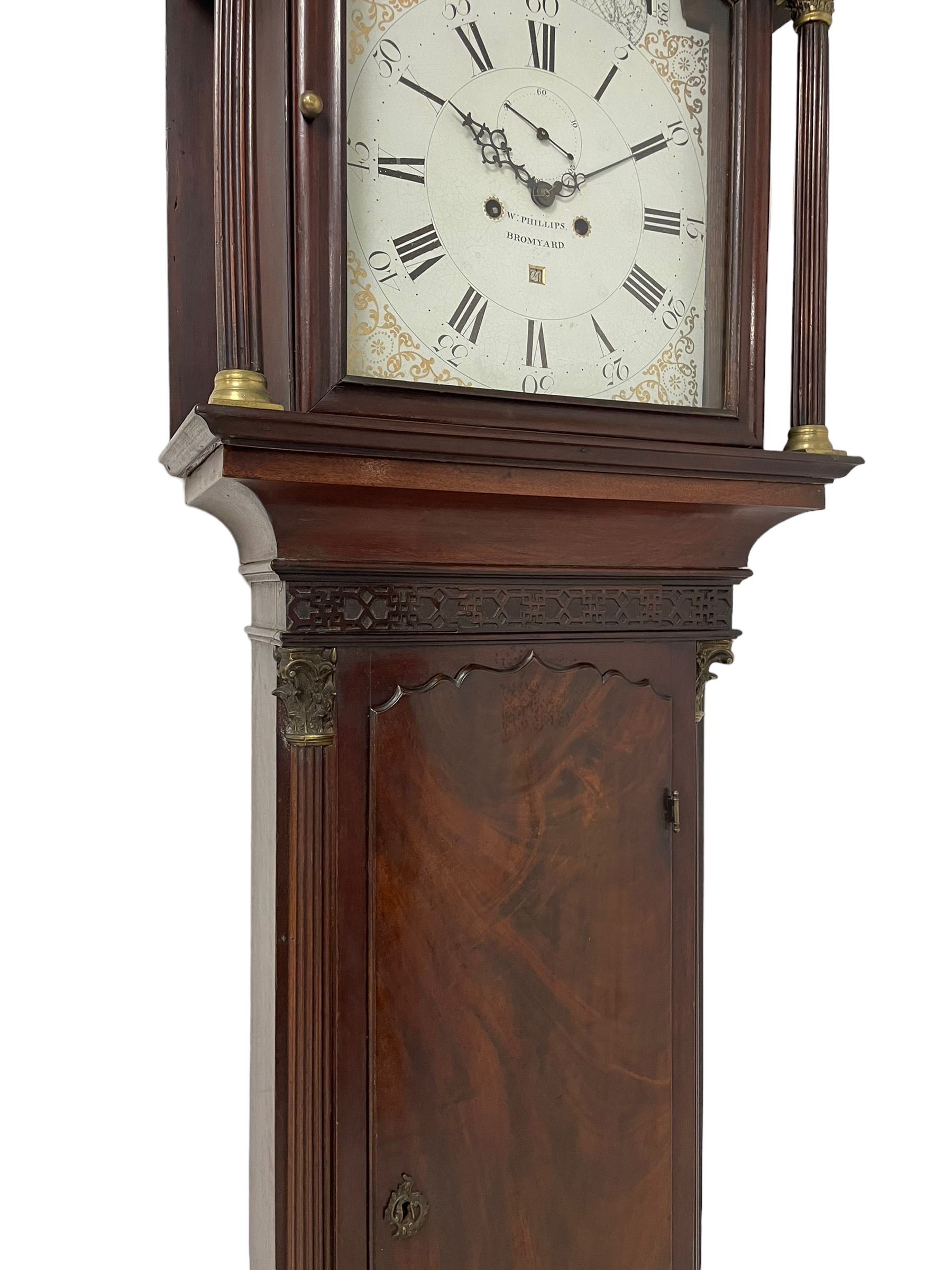 W. Phillips of Bromyard - 8-day mahogany longcase with a painted moon roller dial, c 1790,
swans neck pediment with dog tooth moulding, raised carving and  brass paterie, break arch hood door beneath flanked by reeded pilasters with brass Corinthian capitals, trunk with a blind fret, reeded quarter columns and long wavy topped door,
Plinth with a deep moulding and canted corners raised on a shaped base, painted dial with gesso spandrels, Roman numerals, five minute Arabic's and minute dots, with steel hands, seconds dial and square date aperture, dial pinned to a rack striking movement with an anchor escapement, striking the hours on a cast bell. A clockmaker by the name of John Phillips is recorded as working in Bromyard (Worcs)  in the early to mid 18th century, certainly by 1770-90. W. Phillips was possibly an unrecorded son or brother also working in the same family clockmaking business during the later part of the 18th century.
