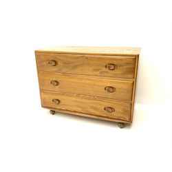 Ercol elm chest, fitted with three long drawers, raised on castors 