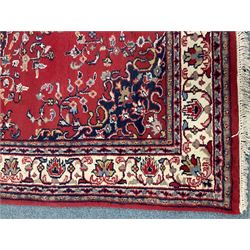 Persian style red ground rug, central medallion, repeating border 