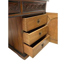 19th century Anglo-Indian teak/camphor twin pedestal desk, raised back fitted with pierced and foliate carved panelled sliding doors, enclosing pigeonholes and correspondence drawers, rectangular top with ebonised banding and moulded edge over a lunette carved frieze, fitted with nine drawers, decorated with carved and pierced mounts