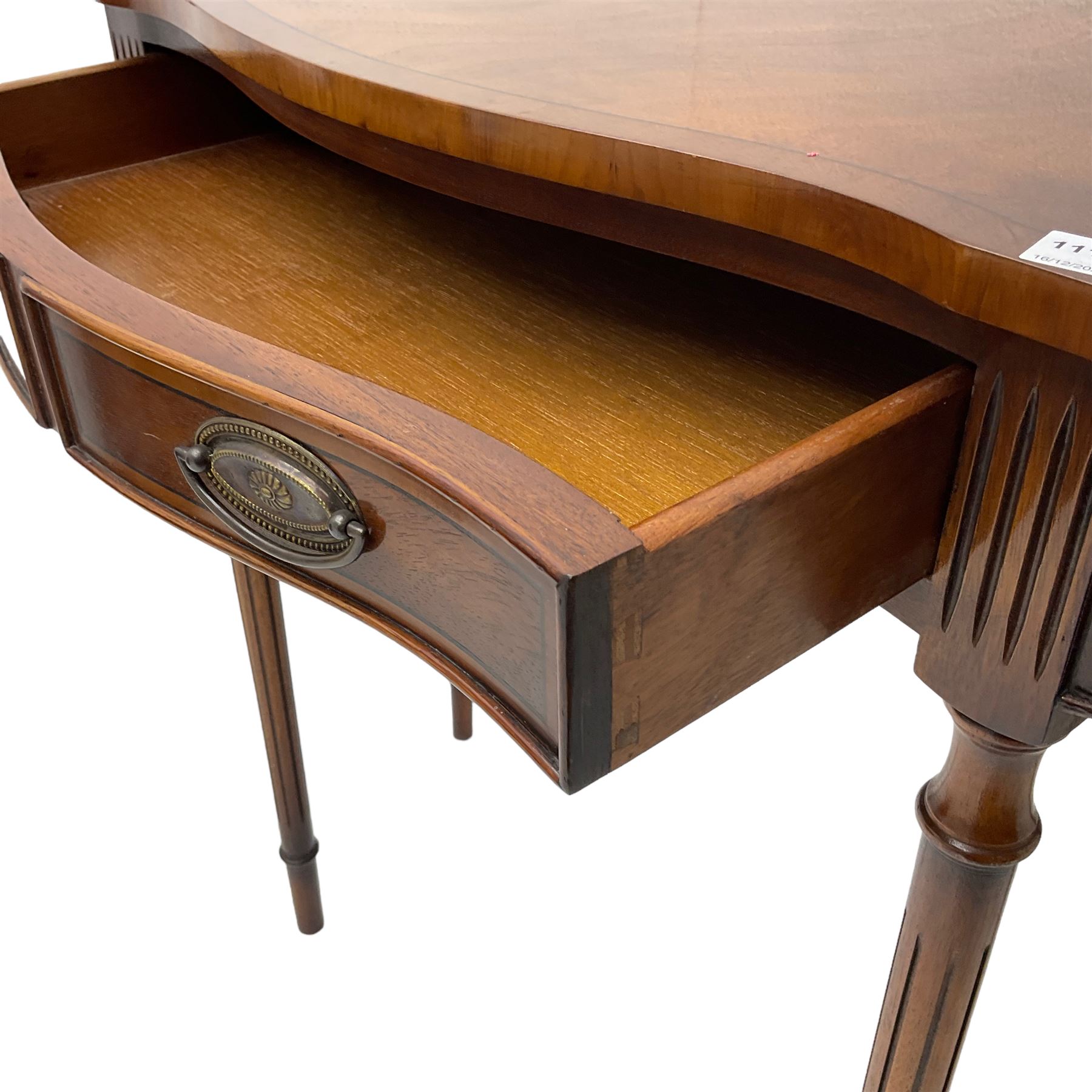 Regency design mahogany serpentine console table, fitted with single drawer disguised as two with cockbeaded facia, raised on fluted tapering supports