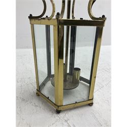 Two Regency style brass vestibule or hall lanterns, glazed hexagonal form with scrolled supports, largest H70cm
