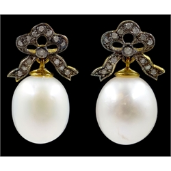 Pair of oval cultured pearl and diamond bow pendant earrings