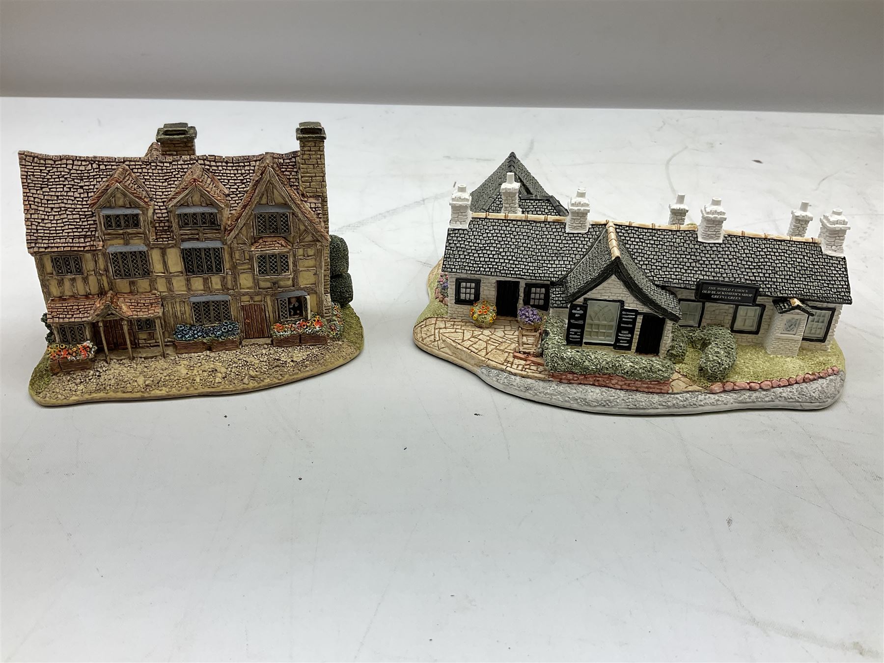 Four Lilliput Lane models from the 'Britain's Heritage' collection, comprising Edinburgh Castle, The World Famous Blacksmith's Shop Gretna Green, Shakespeare's Birthplace and Mickelgate Bar York, together with  a Lilliput Lane Beatrix Potter Hill Top model, all boxed