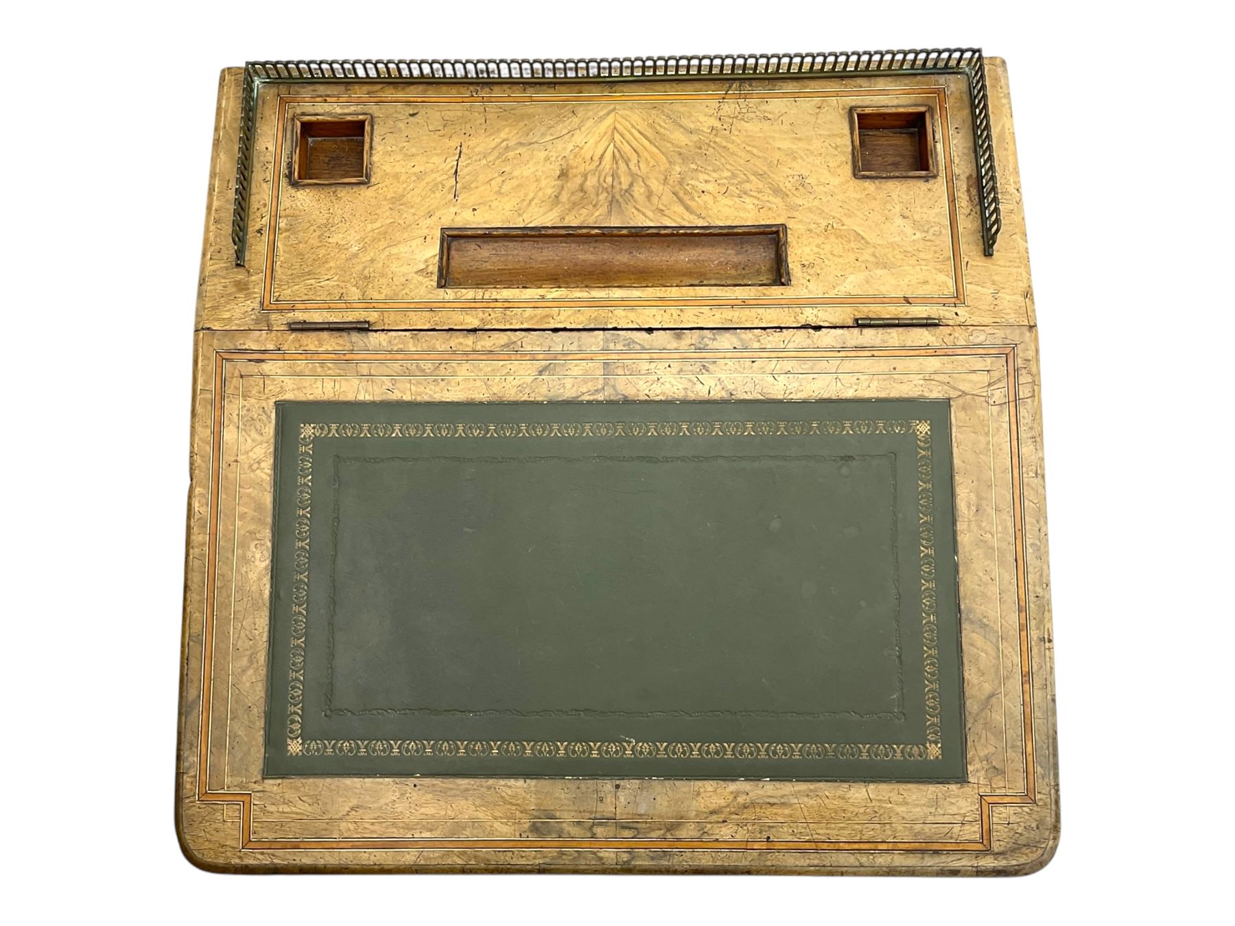 Early 19th century burr walnut Davenport desk, sloped leather-inset writing surface with brass gallery, fitted with an inkwell compartment and pen slot, four drawers to one side, raised on scrolled supports terminating in castors