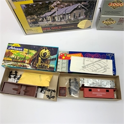 HO scale - nine American goods wagon plastic construction kits comprising three Proto 2000 Series Mather 40' Single Deck Stock Cars and 50 ton War Emergency Hopper, two Tichy Train Group 4024 Wood Reefers, two Athearn hopper wagons and Roundhouse Caboose; together with DPM Gold Coal River Passenger and Freight Depots and two Langley Miniature Models lorry kits, all boxed (12)