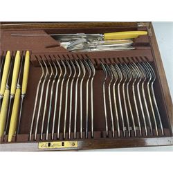 Elkington & Co part canteen of silver plated and stainless steel cutlery, to include simulated ivory handled examples, housed in oak and mahogany case, lock plate stamped 'Acme, British Made', W49cm D31cm H18cm