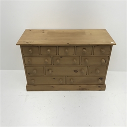  Solid pine thirteen multi-drawer chest, plinth base, W157cm, H77cm, D50cm  