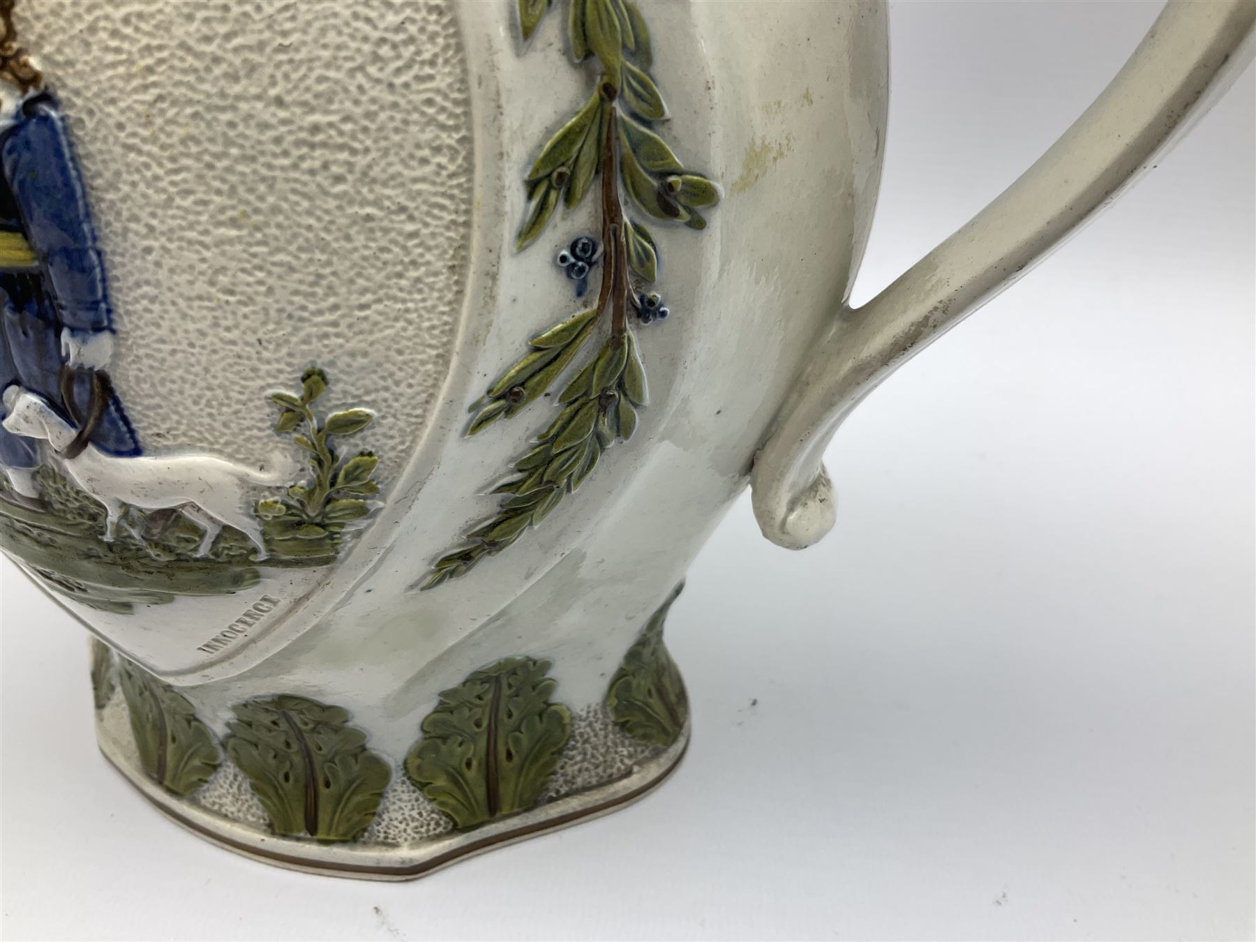 Early 19th century Prattware jug, circa 1800, decorated with two heart shaped panels of children, titled Sportive Innocence and Mischievous Sport, further decorated with acanthus and foliate borders, H22cm