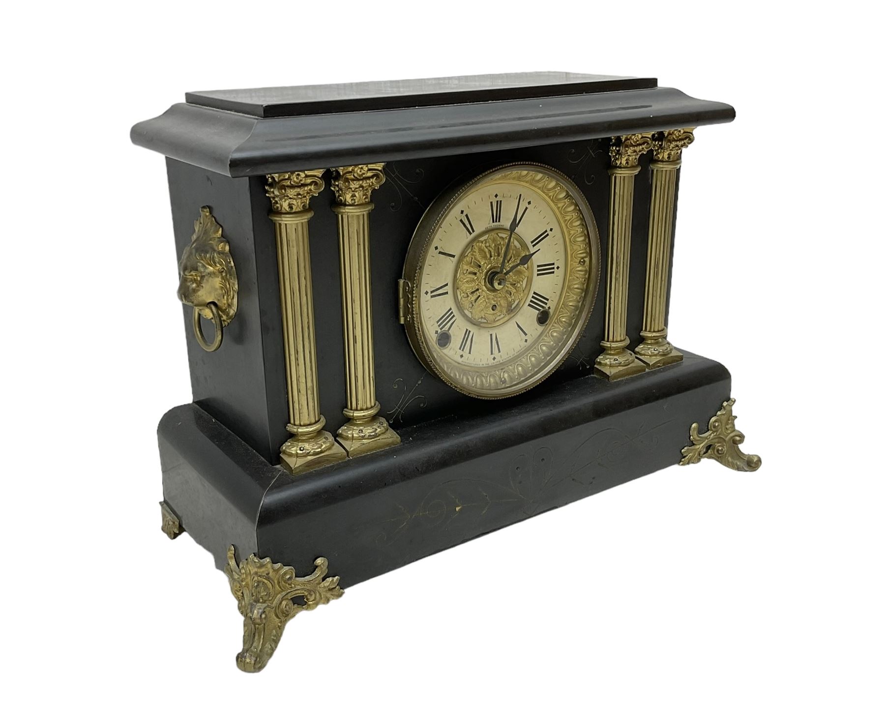 Seth Thomas - American 8-day late 19th century faux slate mantle clock, wooden case with a flat top, decorative gilt metal columns, lion heads and splayed feet,  two part dial with a gilt centre and Roman numerals to the chapter, within an ornate glazed bezel, twin train spring driven movement striking the hours on a coiled gong and the half hours on a bell. 