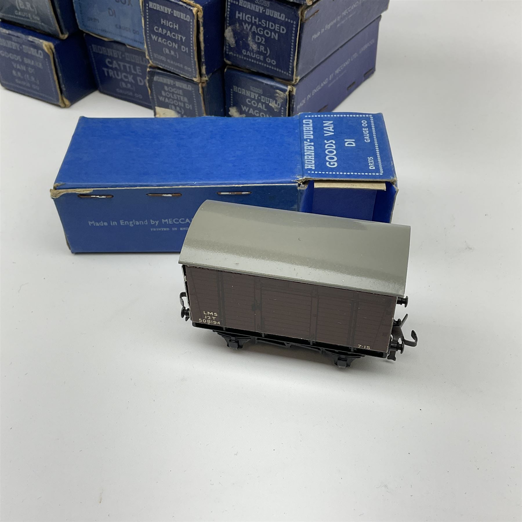 Hornby Dublo - thirteen D1/D2 wagons comprising High Capacity Wagon; Bogie Bolster Wagon; Horse Box; Oil Tank Wagon 'Royal Daylight'; Meat Van; Cattle Truck; Open Wagon; Coal Wagon; Fish Van; Goods Van; Goods Brake Van; Mineral Wagon; and High Sided Wagon; all in dark blue boxes (13)