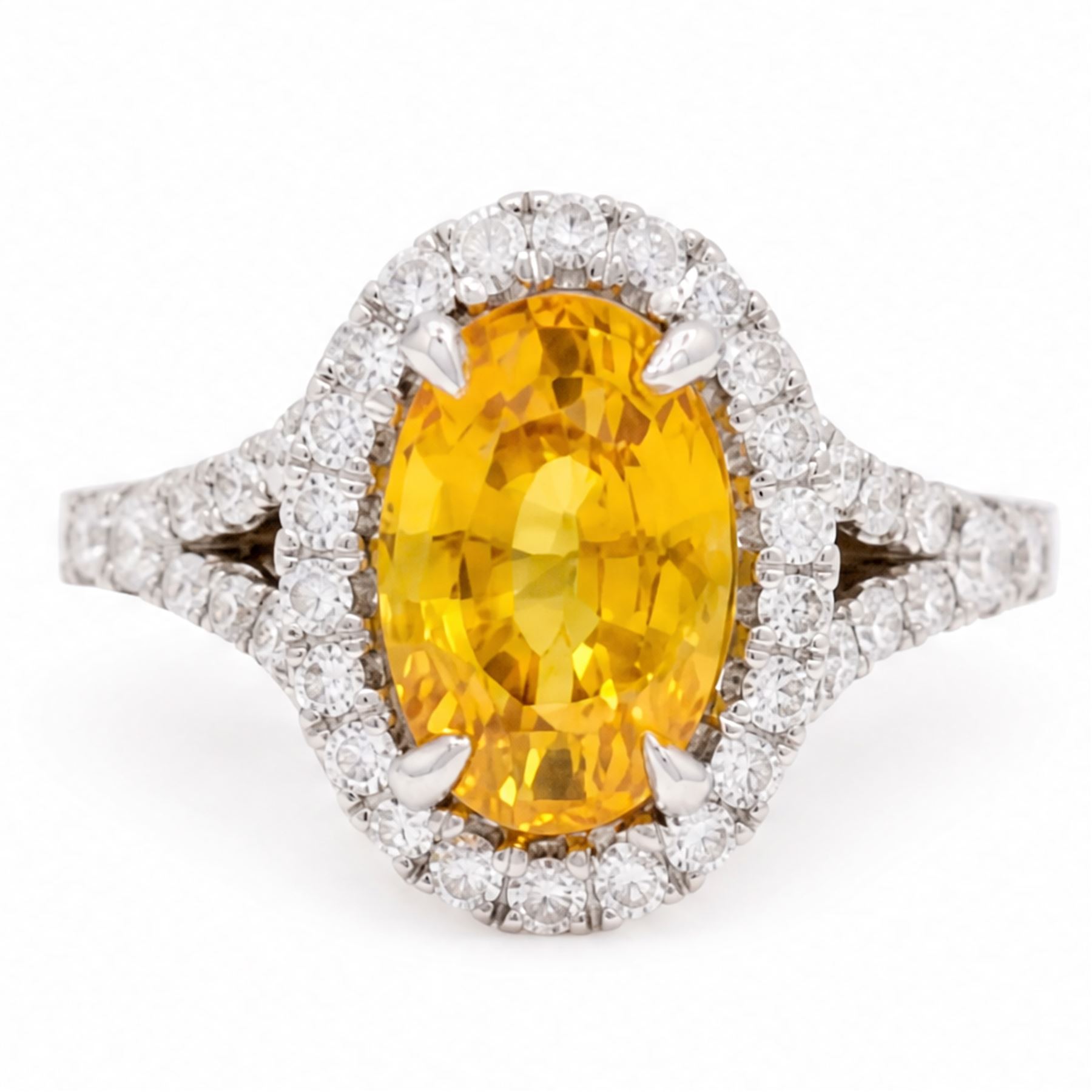 18ct white gold yellow sapphire and diamond ring, single oval cut sapphire of approx 4.20 carat, surrounded by round brilliant cut diamonds and split diamond set shoulders, hallmarked, with World Gemological Institute report