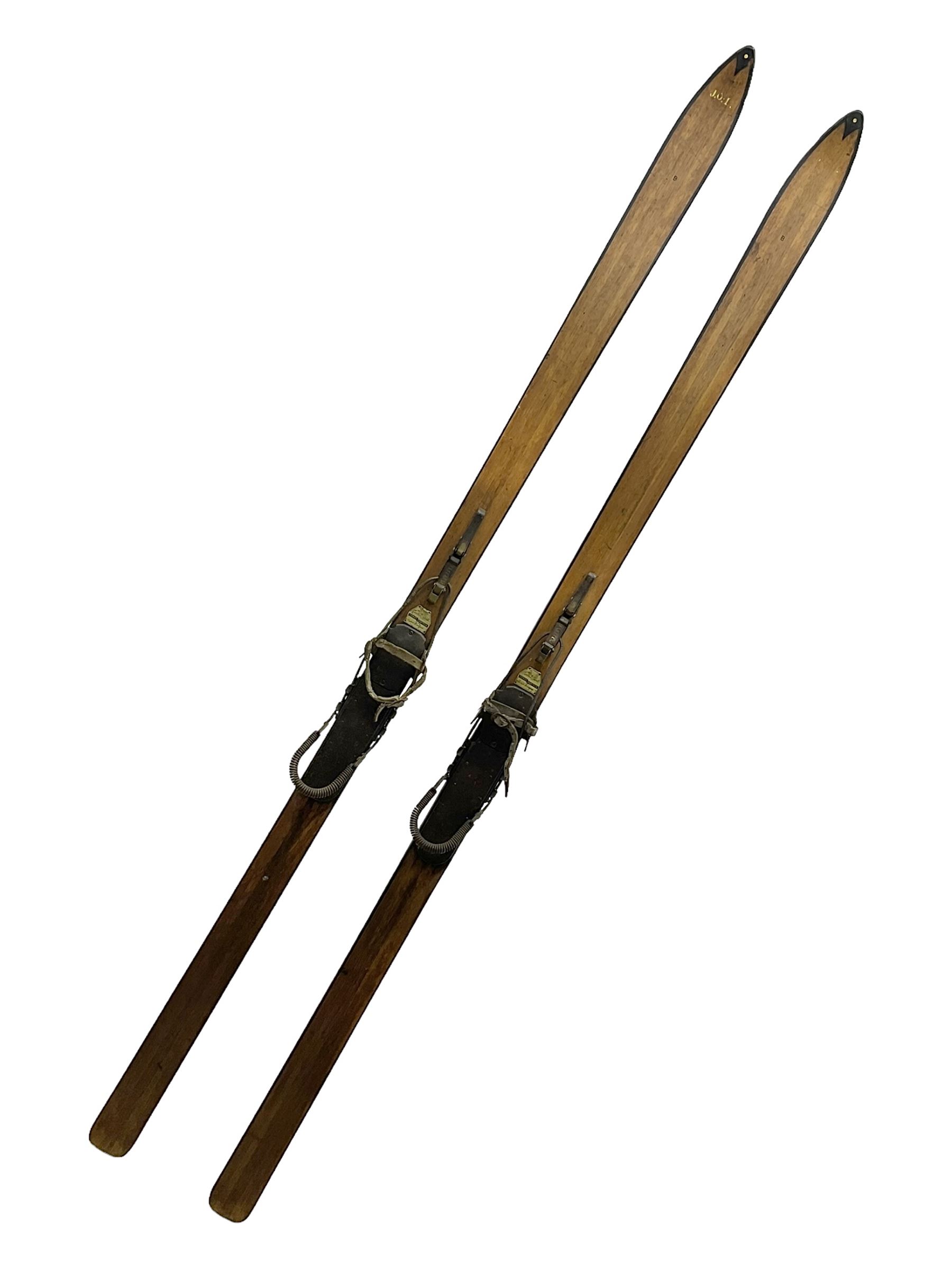 Pair of 1930s wooden skis, with painted metal runners beneath stamped Attenhofer, with retailers label for Ernst Gertsch Central Sports, L206cm