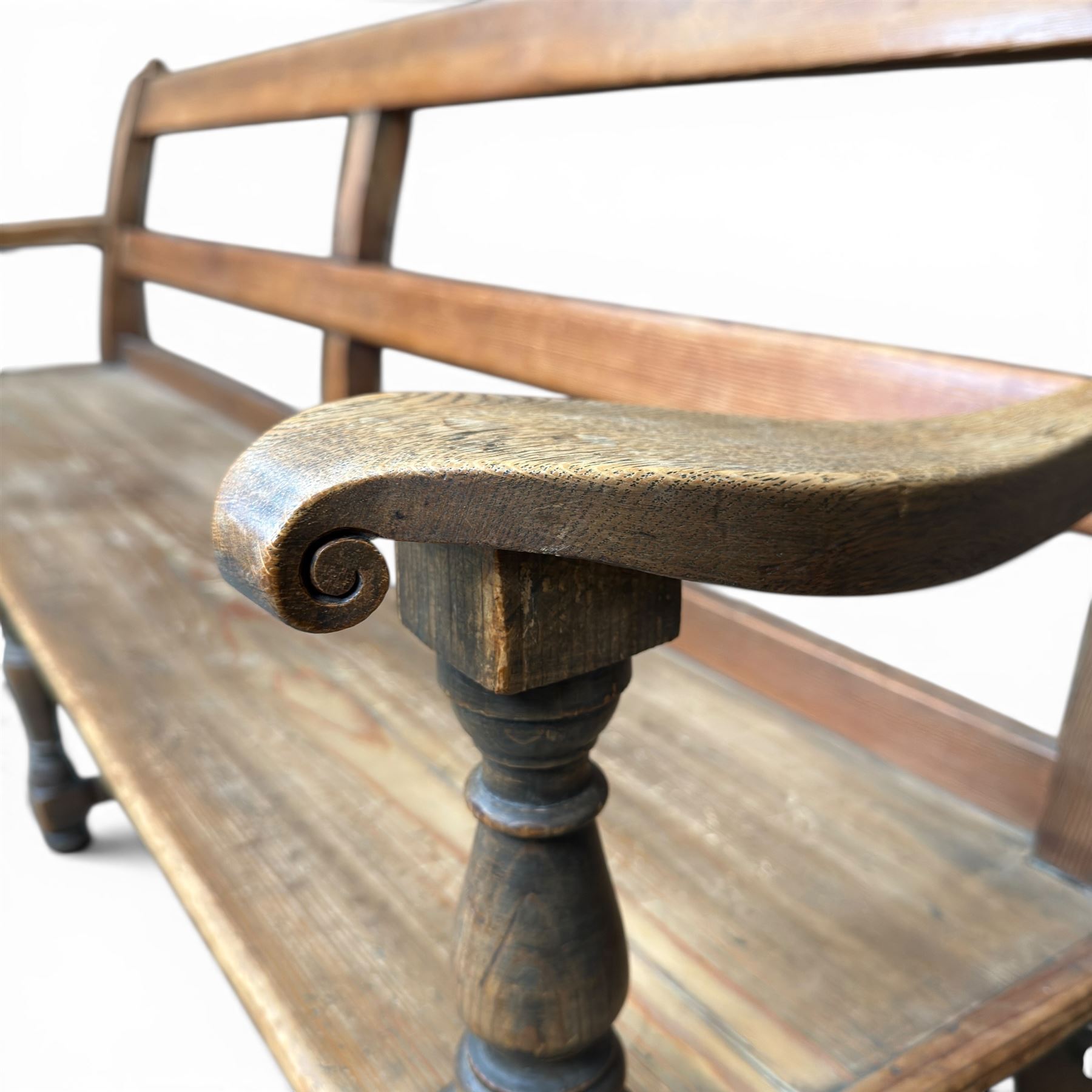 Early 20th century pine and oak bench seat, stained pine rail back frame with shaped oak arms