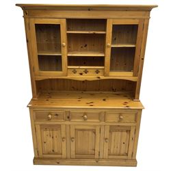 Traditional pine dresser, the rack fitted with two shelves flanked by glazed cupboards, the base with three drawers over three panelled cupboards