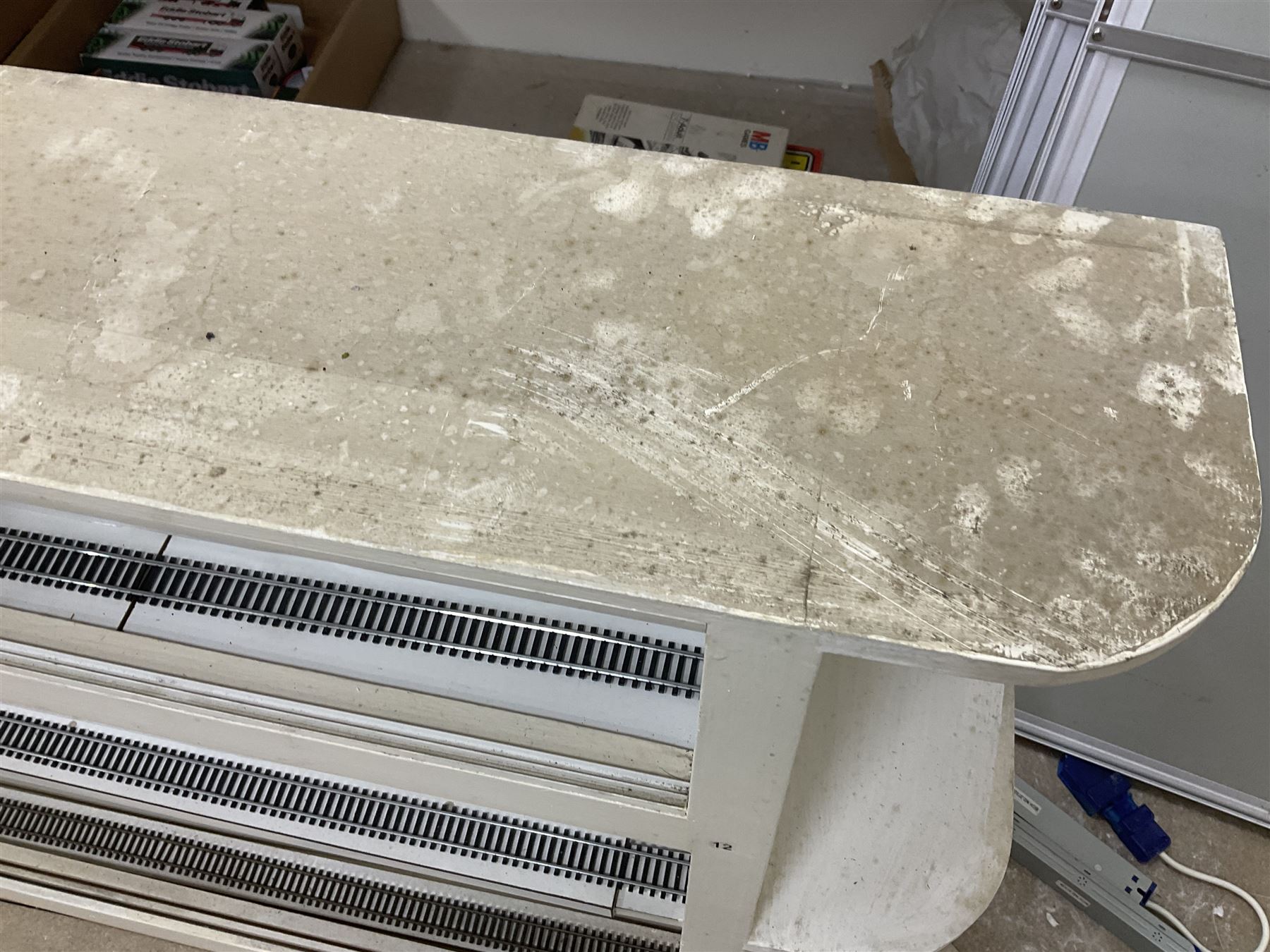 Six shelved cabinets for displaying ‘00’ gauge locomotives comprising plain plywood and white painted examples with track applied to various shelves, largest H63cm, W107cm, D27cm; Collection of tools for building model locomotives to include Weller PU-2D Soldering Pencil and Standard Tip Soldering Iron 20W/230V, Humbrol Modellers Airbrush, Power Supply Units and two wooden chests one of which housing a collection of tools including tweezers, scalping tools, wrenches etc 