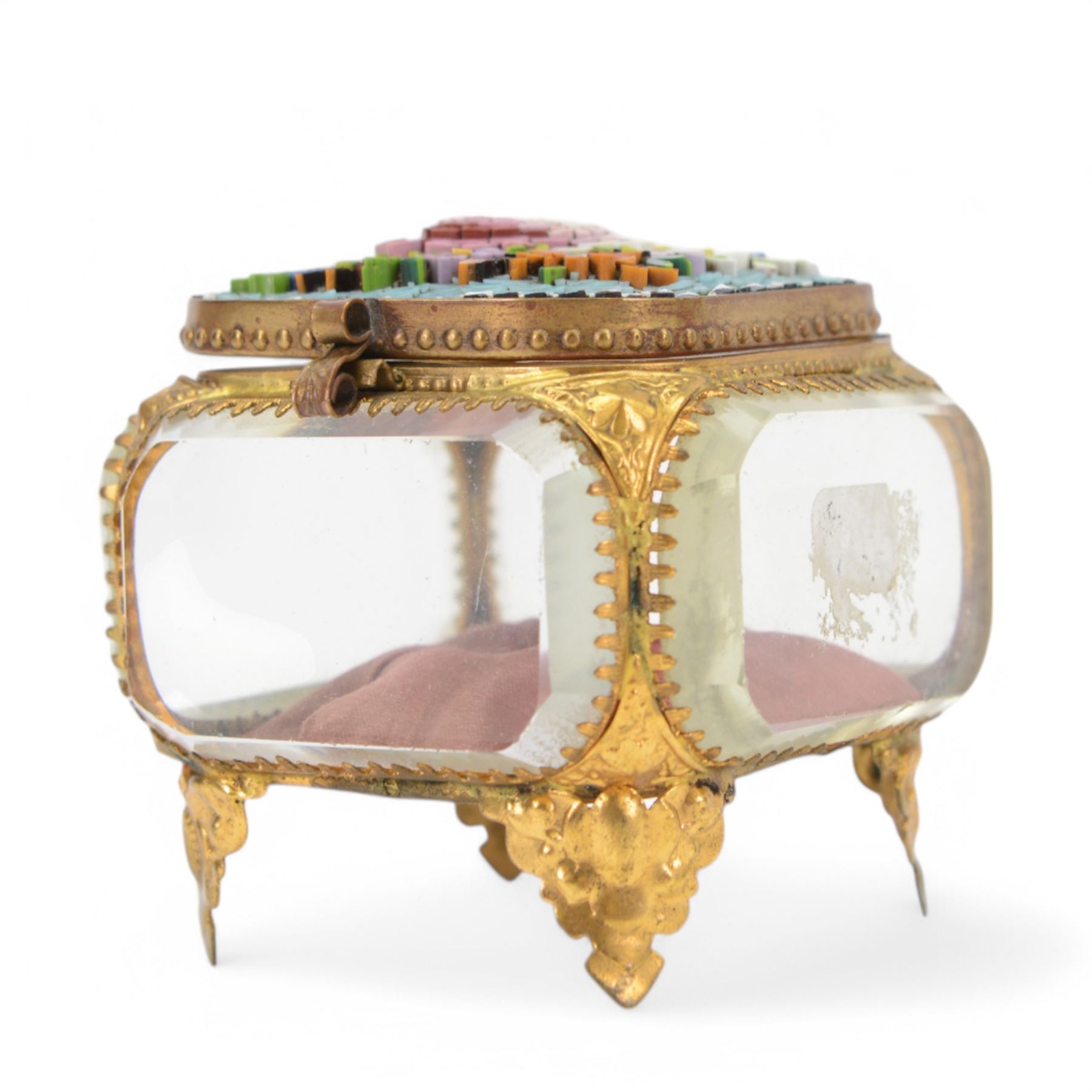 
Two Micro mosaic jewellery caskets with bevelled glass sides, the hinged lid decorated with raised flowers upon a blue ground, raised upon pierced gilt feet, largest H7cm 
