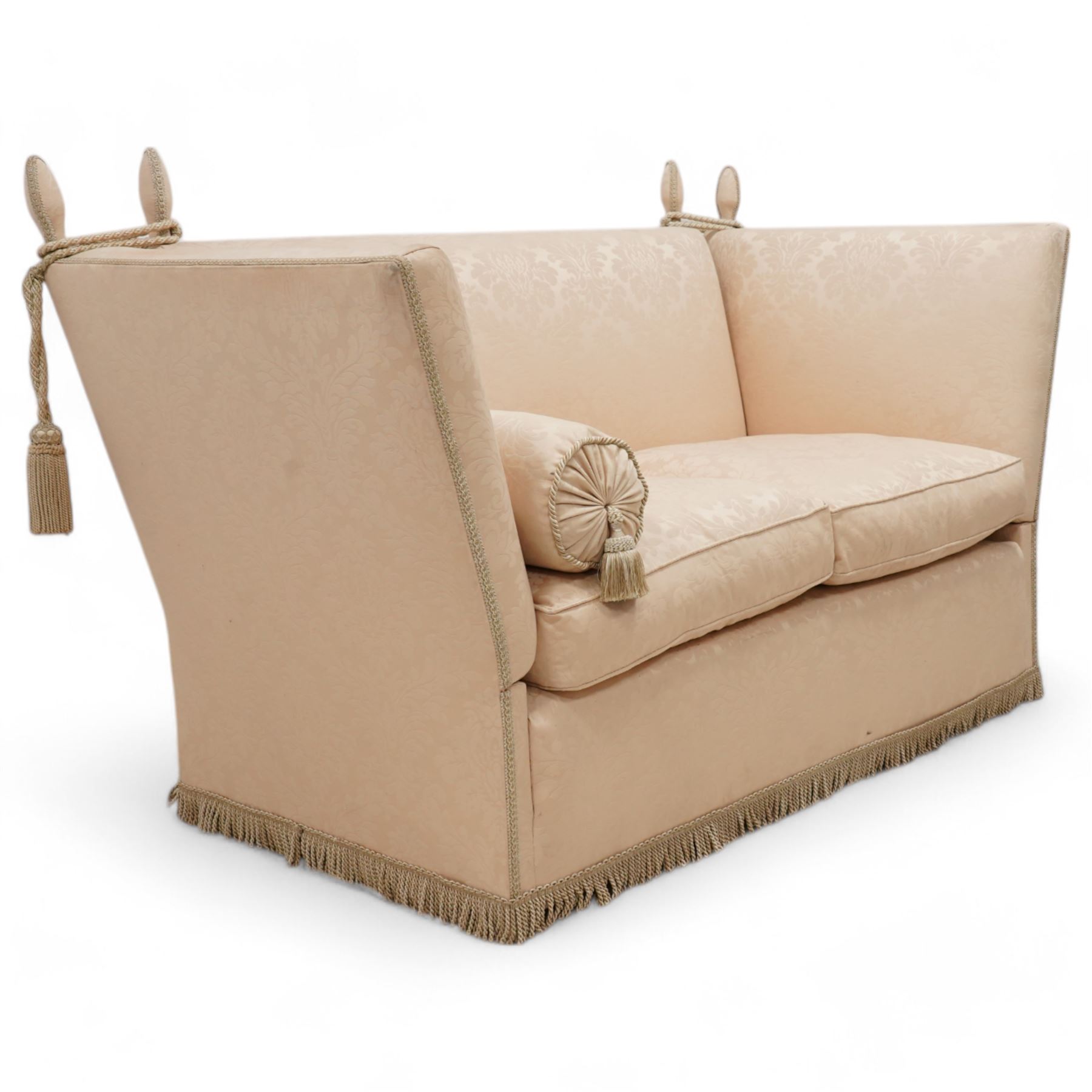 Knole design hardwood-framed drop-arm two-seat sofa, upholstered in cream Damask fabric decorated with repeating foliate pattern, with twist fringe, 