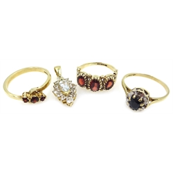 Two three stone garnet gold rings, a sapphire and diamond gold ring and a gold marquise dress pendant all hallmarked 9ct