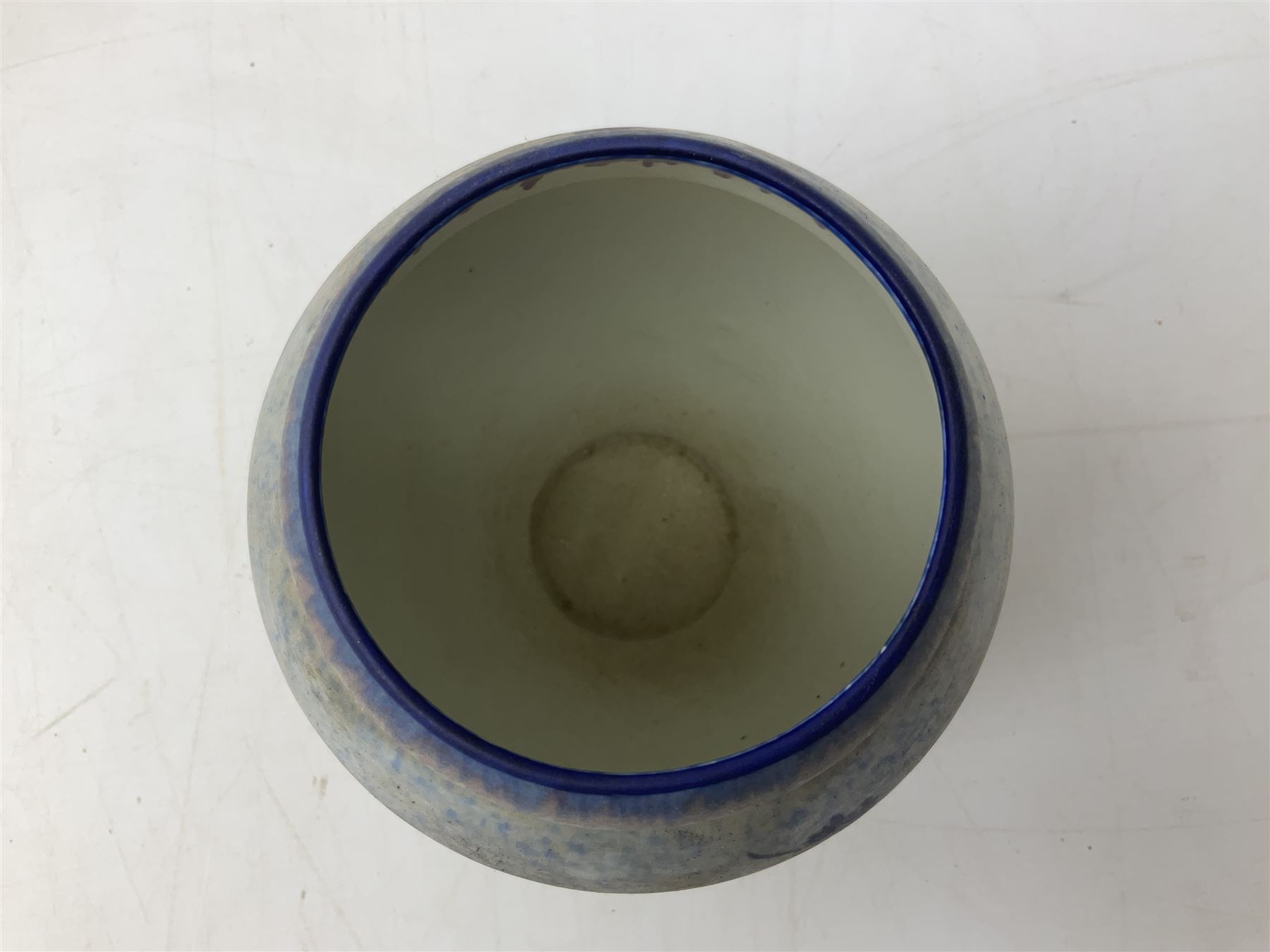 1930s Carlton Ware Art Deco Garden pattern vase of shouldered ovoid form, decorated with blue, pink and yellow flower heads on a mottled blue and white ground, pattern no. 3413, with printed and painted marks beneath, H19cm, together with a Clarice Cliff My Garden pattern vase, raised upon three feet with blue, pink and purple moulded Hollyhock design, H20cm, with Clarice Cliff Wilkinson Ltd England marks beneath