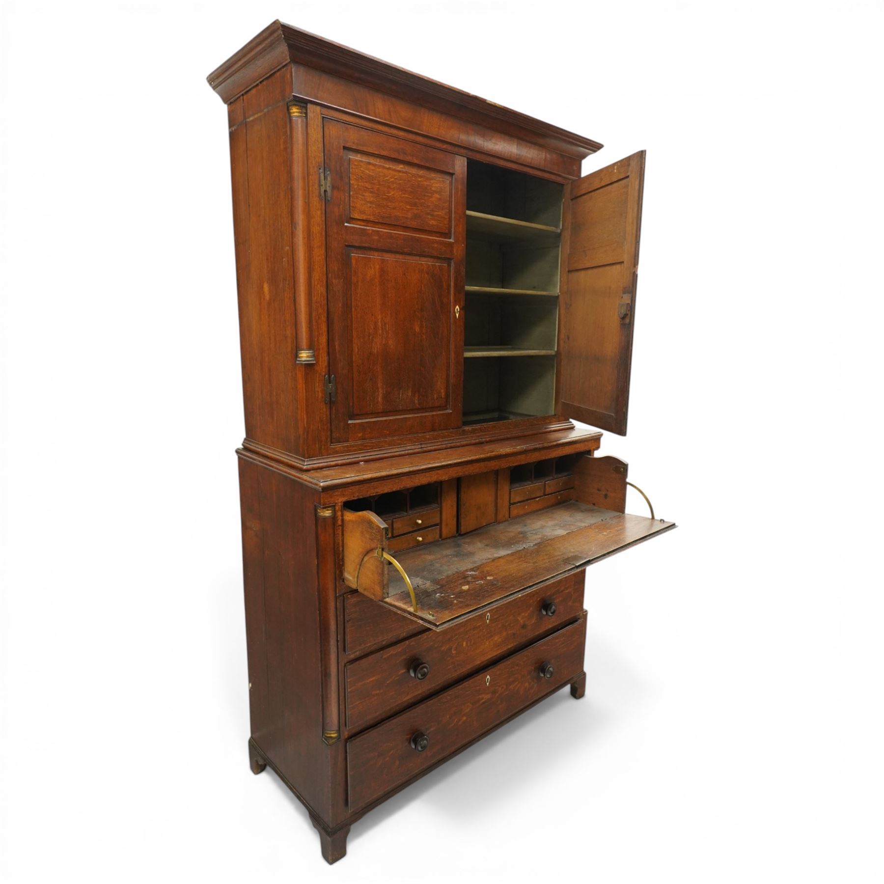 George III oak and mahogany bound enclosed bookcase-secretaire, panelled cupboards over four drawers