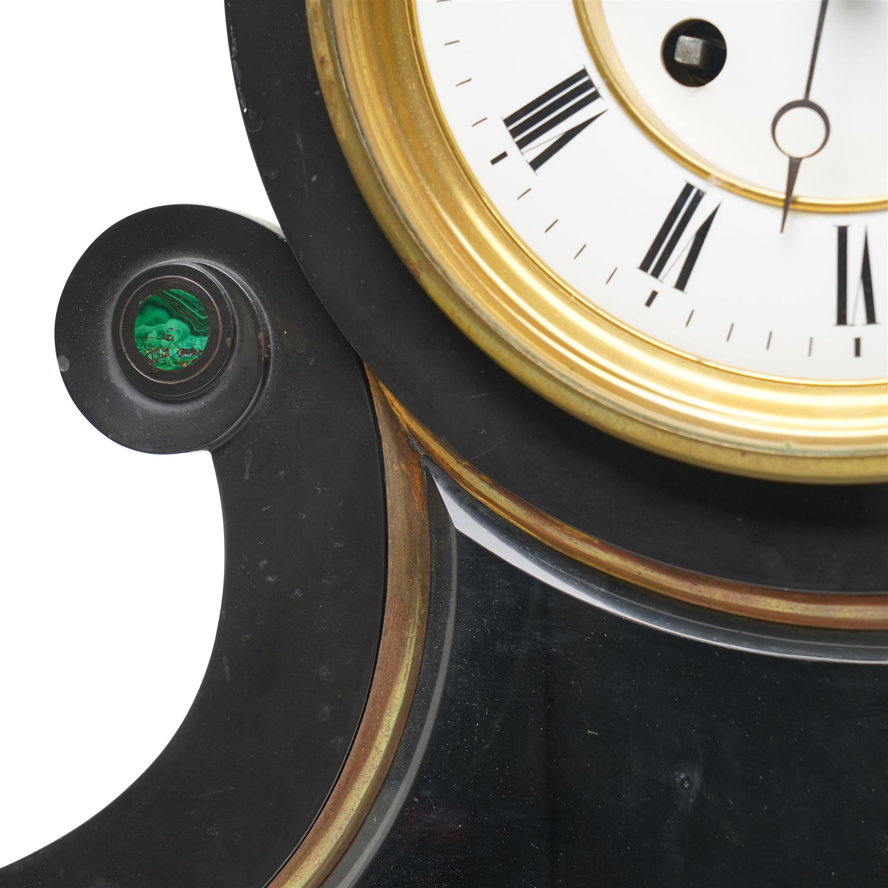 French-Late 19th century Belgium slate mantel clock, 8-day movement housed in a drum case with volutes, cradled within scroll supports and a shaped pendulum viewing glass with a brass surround, stepped plinth with incised decoration and malachite panels, two-piece enamel dial within a cast brass bezel, dial with Roman numerals, minute markers and steel moon hands, visible Brocot dead-beat escapement fitted with cornelian pallets, twin train going barrel movement with rack striking, sounding the hours and half-hours on a bell. With the original twin file mercury pendulum.
 