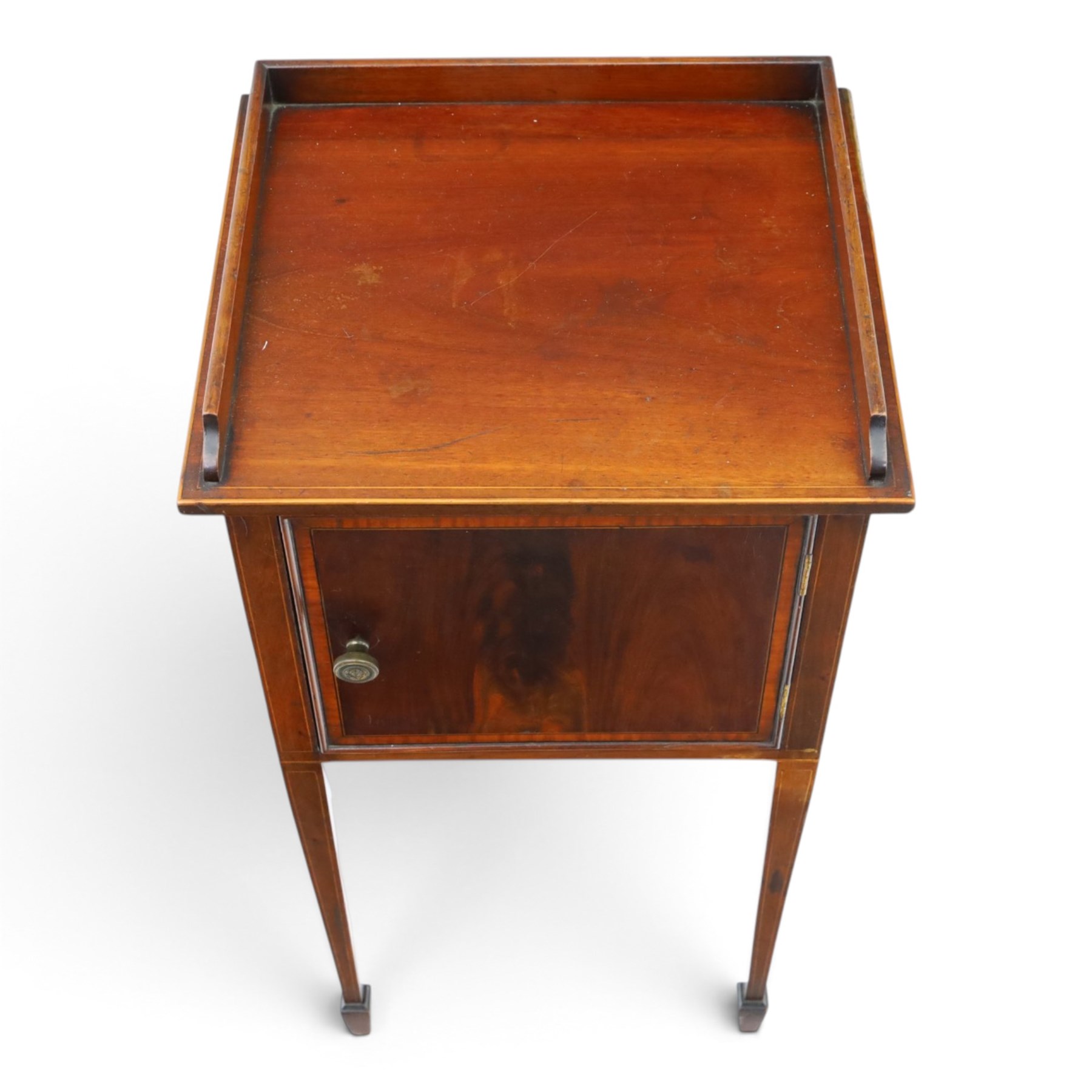 Edwardian mahogany pot cupboard, with three quarter galleried top, single cupboard door, raised on square tapering supports terminating in spade feet