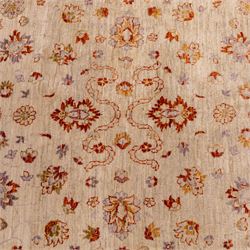 Indian Agra hand knotted rug, the pale beige field decorated with scattered floral sprays and stylised palmettes, enclosed within a wide terracotta border of scrolling foliage and flowerheads between narrow guard bands, finished with fringe ends