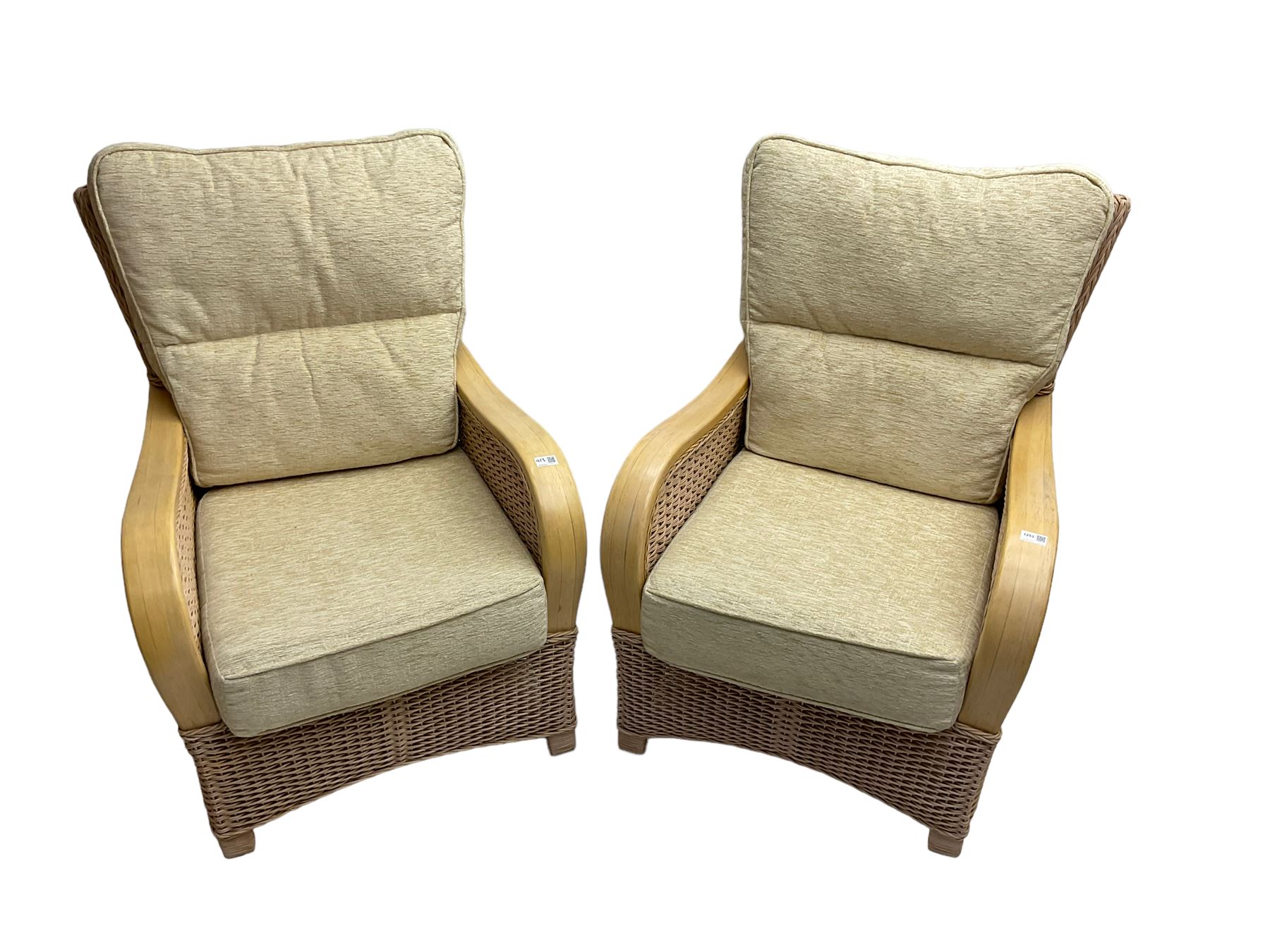 Contemporary rattan conservatory suite - two seat sofa with wicker frame and loose cushions upholstered in textured champagne fabric (W125cm H98cm); pair of matching armchairs (W72cm H98cm); rectangular glass-topped coffee table with rattan frame and undertier (W85cm D60cm H47cm); and matching square side table (W53cm H55cm)