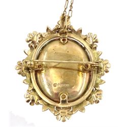 Gold hinged locket pendant/brooch, with foliate border, hallmarked, on 9ct gold link chain necklace