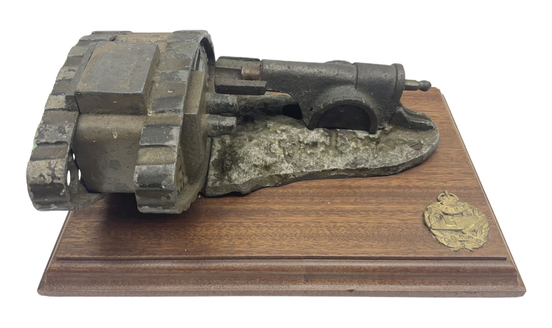 Early 20th century mechanical money bank 'Tank and Cannon' by Starkies, mounted on an oblong mahogany base with WW1 Tank Corps cap badge; patented 16th January 1919 L29.5cm