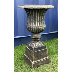 Cast iron Campana shaped urn on plinth, the rim decorated with egg and dart moulding, waisted lobed body with gadrooned underside, square tapered plinth  - THIS LOT IS TO BE COLLECTED BY APPOINTMENT FROM DUGGLEBY STORAGE, GREAT HILL, EASTFIELD, SCARBOROUGH, YO11 3TX