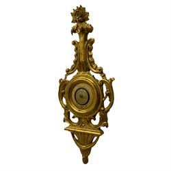 A 20th century Italian barometer in a carved gilt wood case in the late 18th century rococo style, with an English aneroid movement, steel indicating hand and contrasting recording hand, with weather predictions.

