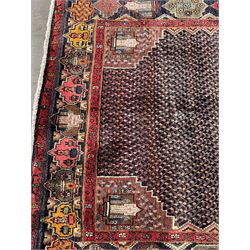 Persian Hamadan blue ground rug, medallion on field decorated with repeating motifs, the guarded border with multiple medallions decorated with flower heads and stylised motifs
