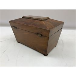 Mid 19th century mahogany tea caddy of sarcophagus form, the hinged lid opening to reveal twin lidded divided interior, raised upon four compressed bun feet, H14.5cm W22.5cm D13cm