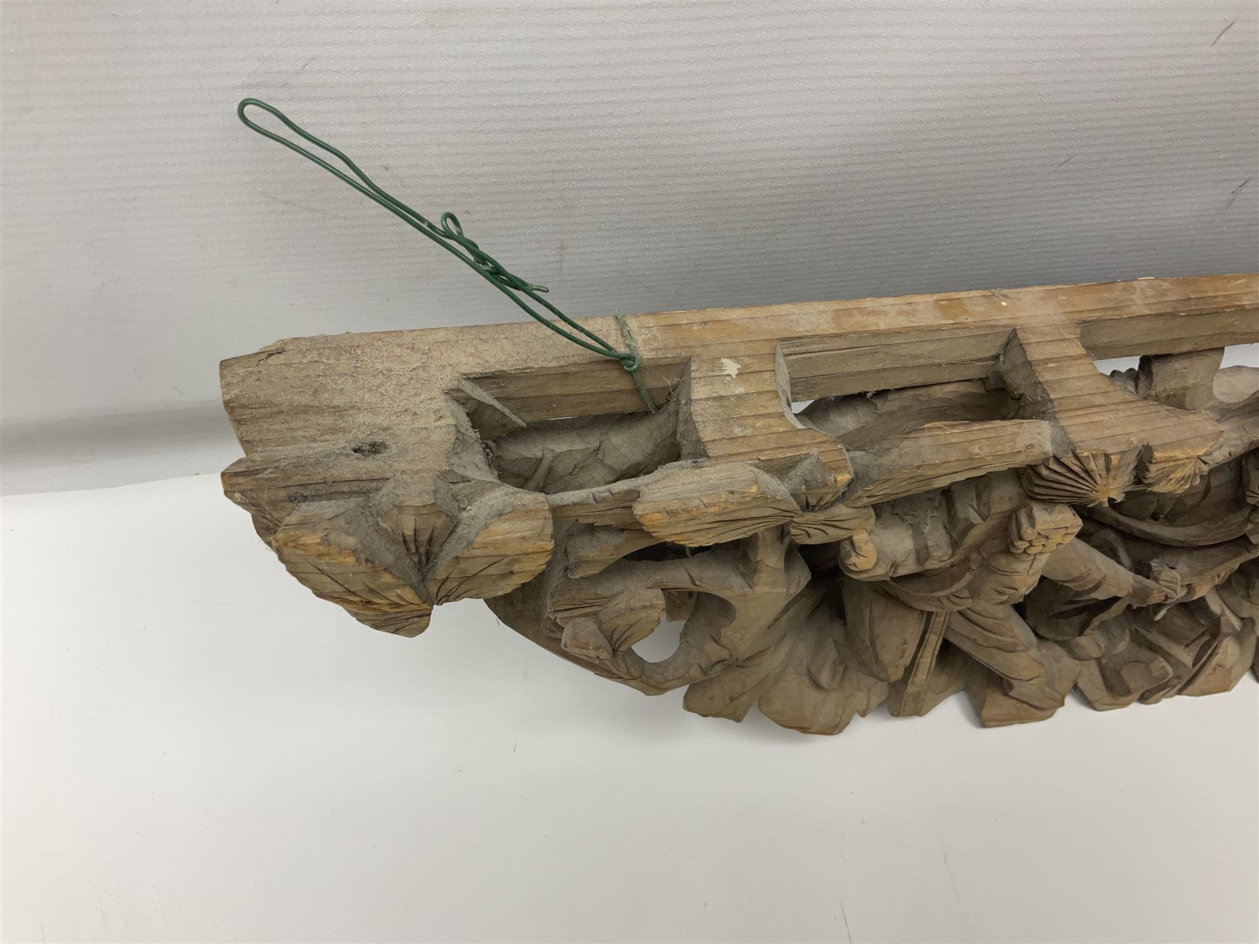 Two carved oriental wall hangings, the first example gilded depicting a temple and garden scene, the second figures in a garden, L49cm