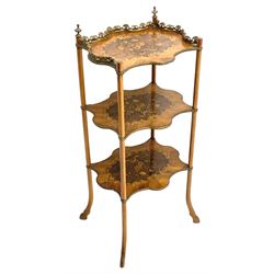 Late 19th century French inlaid Kingwood and walnut étagère, three shaped tiers, the top tier with ornate gilt cast metal gallery and finials, each inlaid with flowers in scrolling foliate surround, splayed hoof supports 