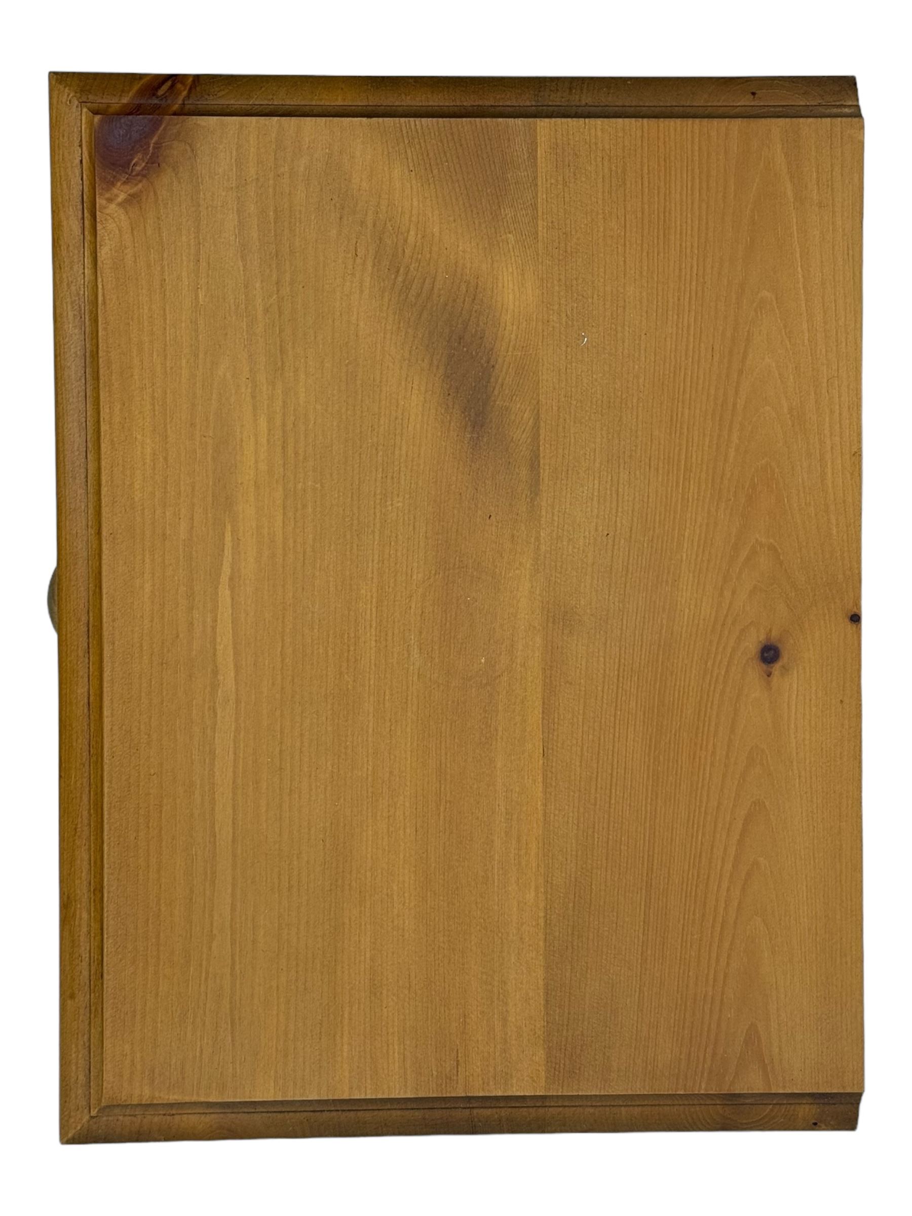 Pine chest of drawers topped with carved pediment with acorn and oak leaf motif, fitted with two short over three long drawers, standing on shaped apron base (W92, D46, H97cm); pine bedside cabinet, single drawer above paneled cupboard door enclosing open storage, shaped plinth base (W43, L32, H67cm)