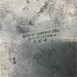 Liberty & Co Tudric pewter Bollelin tray, designed by Archibald Knox, of circular form with shaped edge, cast in relief with foliate tendrils surrounding a green enamel cartouche, impressed beneath Made by Library & Co English Pewter 044, D25.5cm