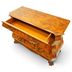 Colombo Mobili - Italian walnut and floral marquetry bombé commode chest, rectangular top with canted eared corners inlaid with urn motif and trailing scrolling foliage, fitted with three long graduating drawers with gilt metal handles, profusely inlaid with scrolling acanthus leaves interspersed with urns and cartouches, on large carved ball-and-claw feet