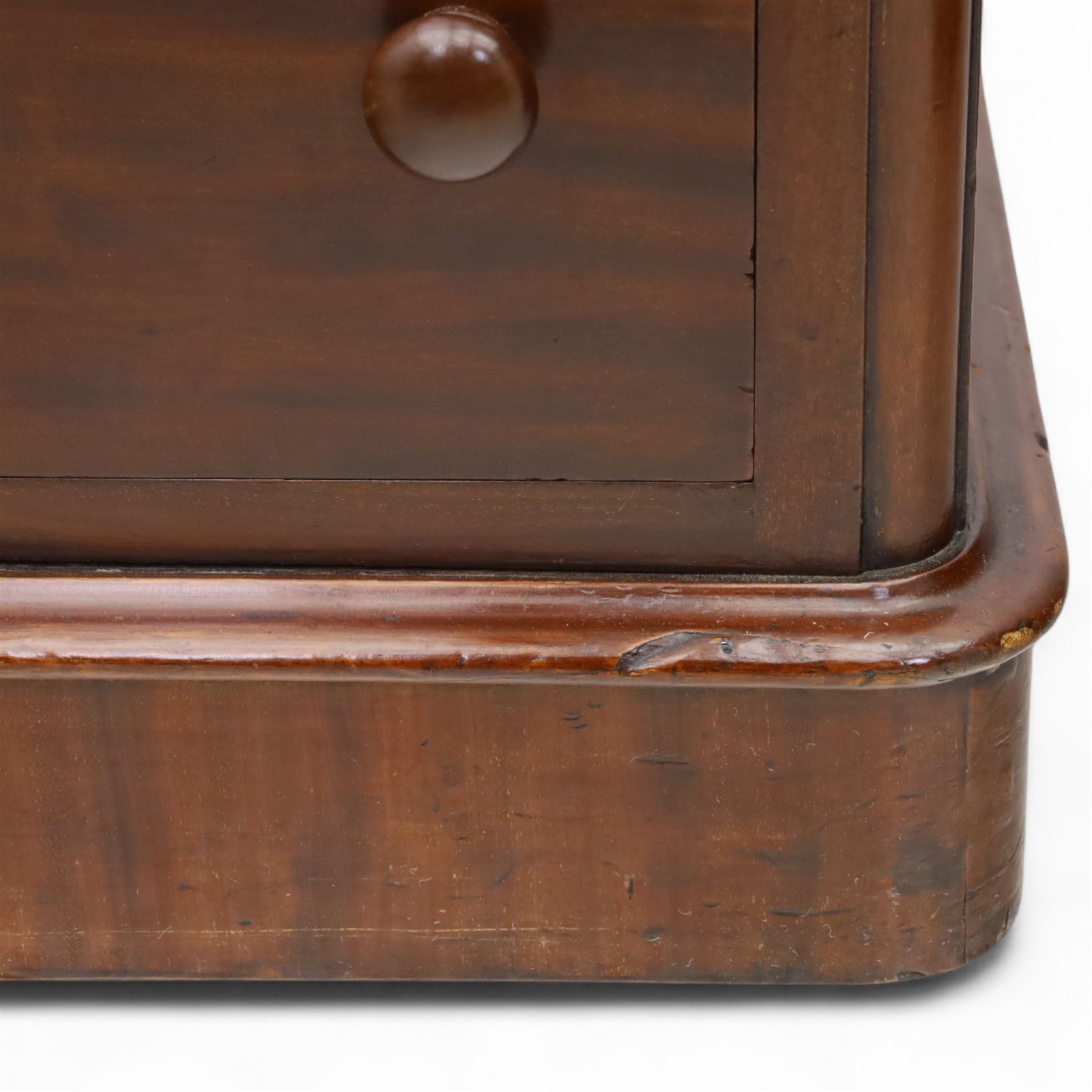 Pair of tall Victorian mahogany bedside chests, of narrow upright form, rectangular top with moulded edge, the back with raised pierced fretwork gallery, above four graduated drawers with knob handles, raised on a plinth base 