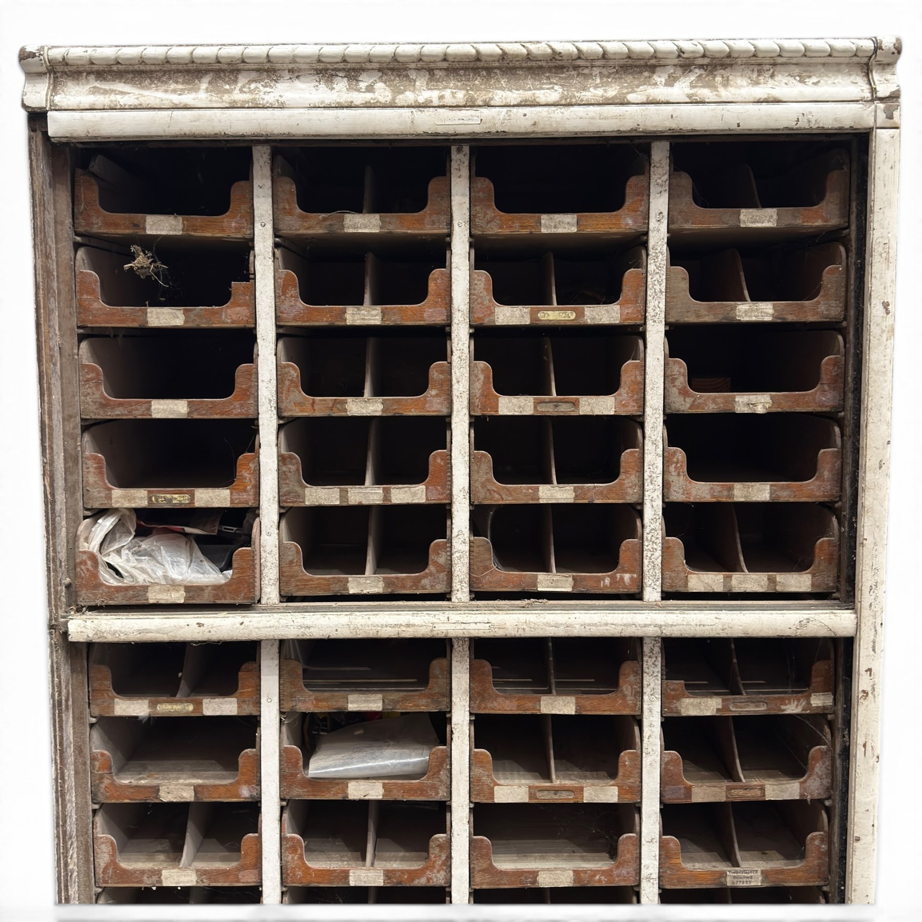 F Pollard & Co - late 19th century rustic haberdashery shop cabinet, fitted with an assortment of forty sliding trays, with drawers fitted to base, in antique white-painted finish