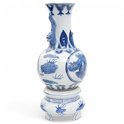 Pair of Chinese blue and white vases and stands, of baluster form with elongated neck, decorated with painted scenes of dragons amongst clouds, the twin handles formed as two crouching dragons, including stands H32cm