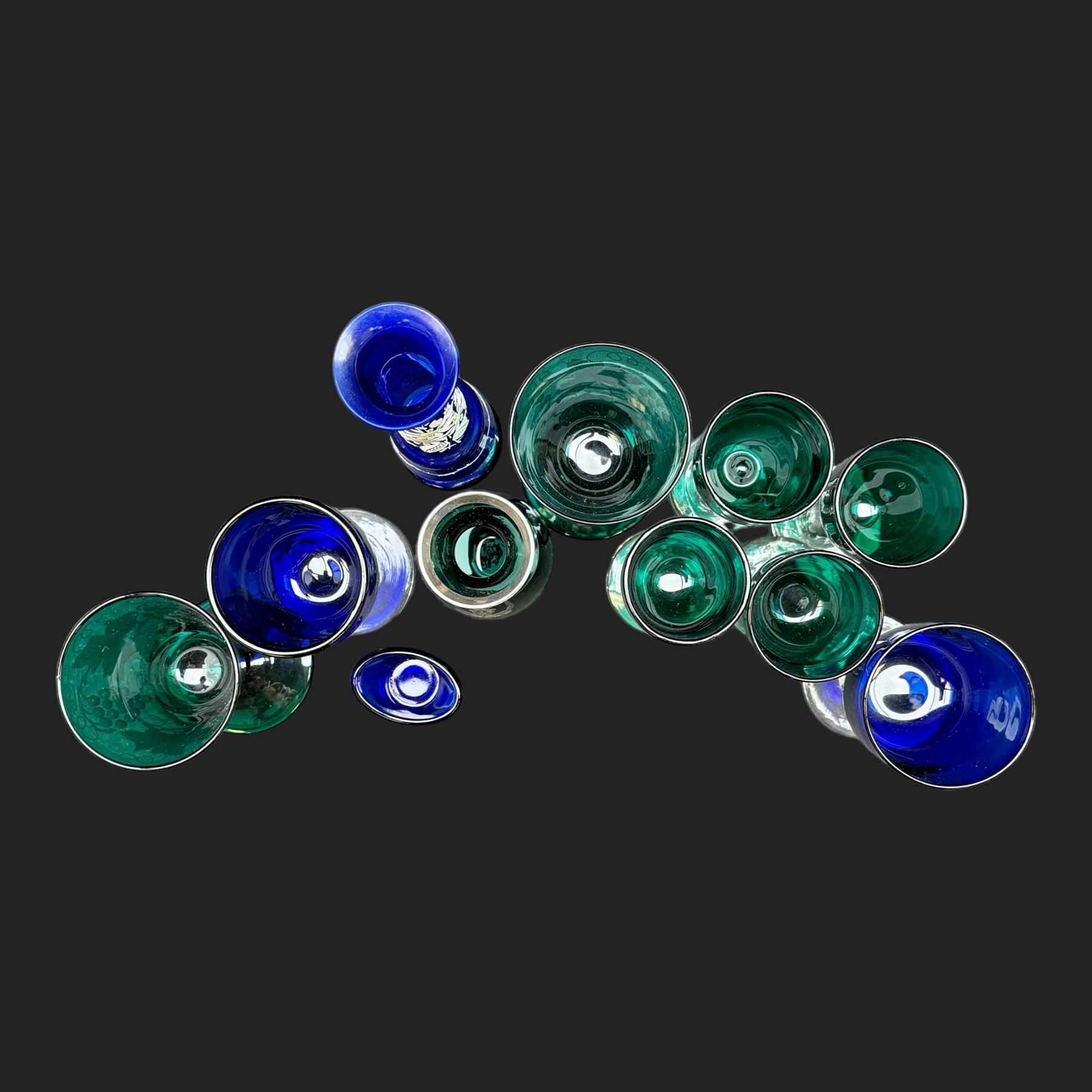 Pair of etched green glasses decorated with grapes and vine leaves, together with  blue glasses and other coloured glassware 