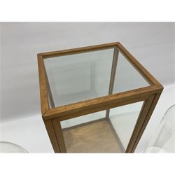 Tabletop glass display cabinet, with hinged door, together with two glass domes